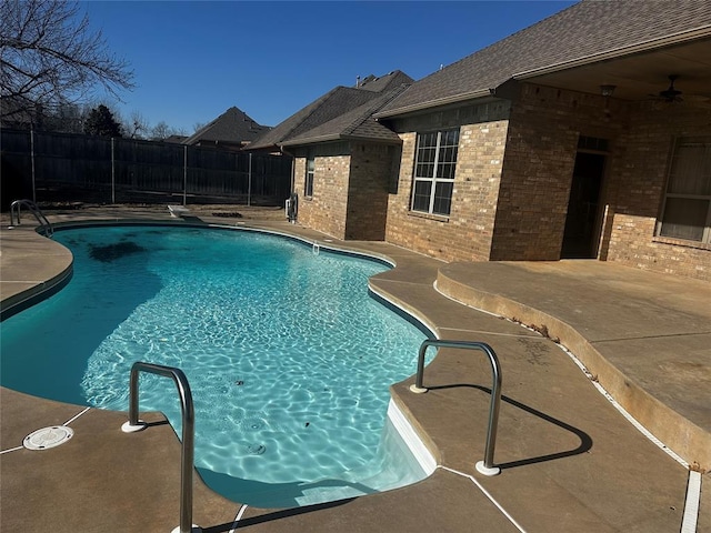 view of swimming pool with ceiling fan and a patio