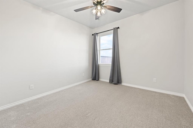 unfurnished room with baseboards, light colored carpet, and a ceiling fan