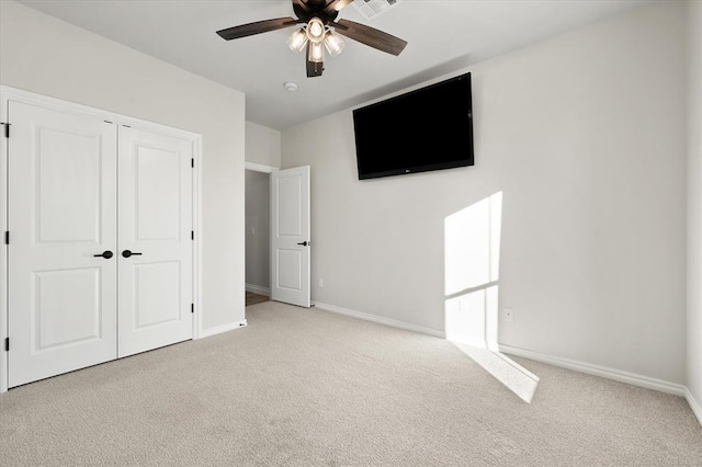 unfurnished bedroom featuring a closet, baseboards, and carpet floors