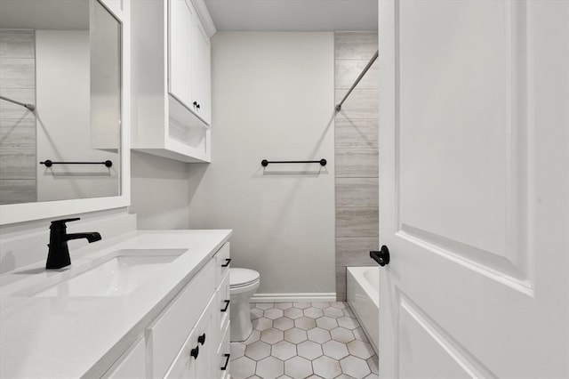 bathroom featuring baseboards, toilet, shower / bathing tub combination, tile patterned floors, and vanity