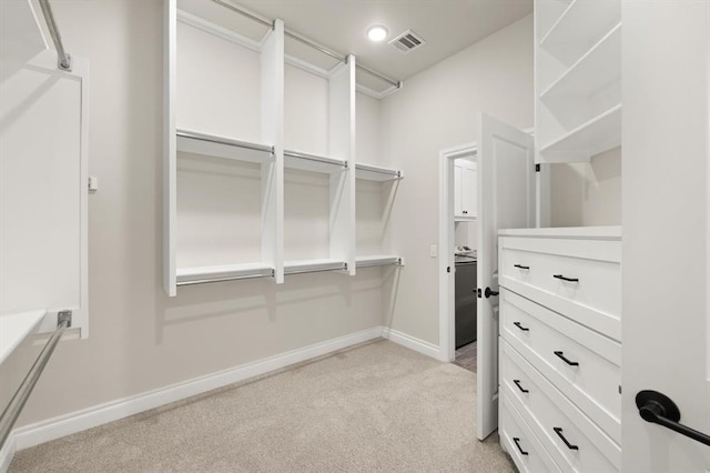 spacious closet with light carpet and visible vents