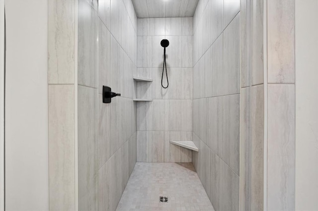 bathroom with a tile shower