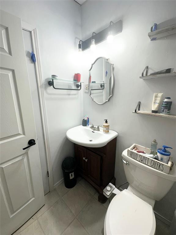 bathroom with vanity, tile patterned flooring, and toilet