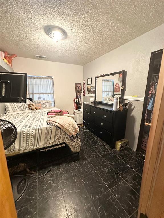 bedroom featuring a textured ceiling