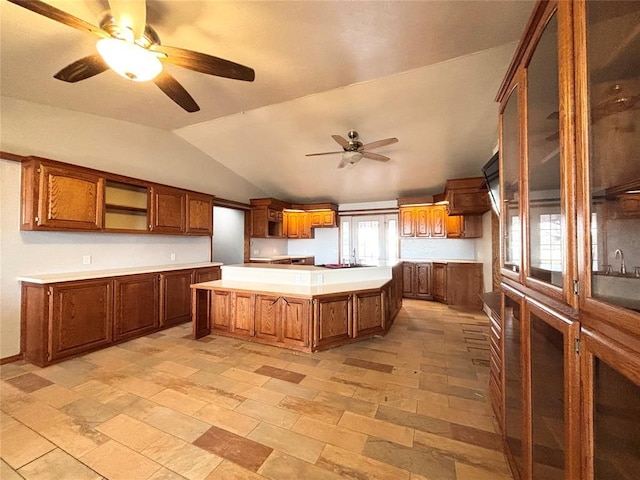 kitchen featuring a kitchen island, ceiling fan, and lofted ceiling