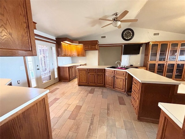 kitchen featuring a kitchen island, light wood-type flooring, ceiling fan, and sink