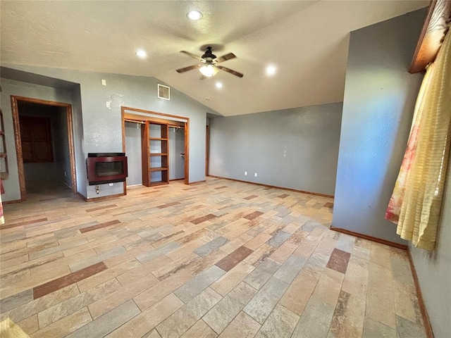 unfurnished living room featuring ceiling fan and vaulted ceiling