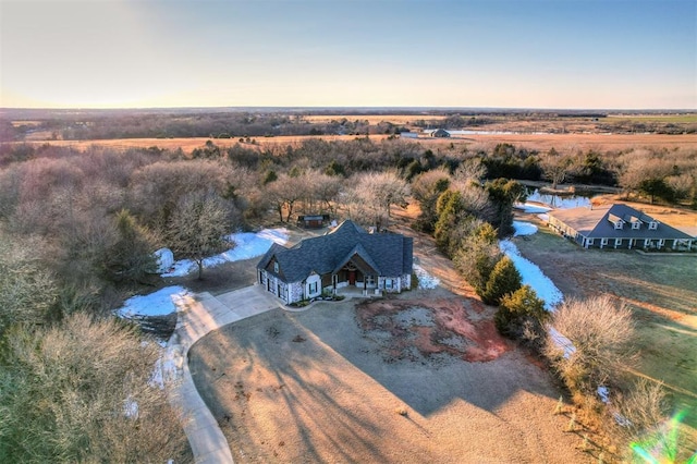 aerial view at dusk featuring a rural view