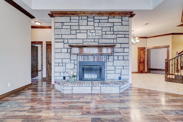 unfurnished living room featuring wood-type flooring, a fireplace, ornamental molding, and a chandelier