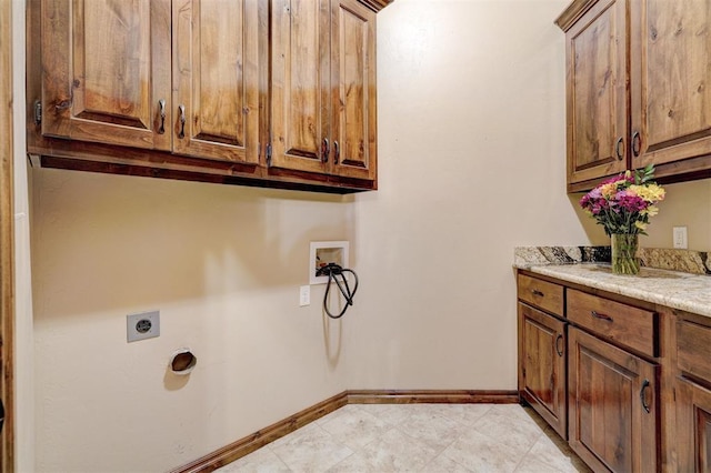 clothes washing area with washer hookup, cabinets, and electric dryer hookup