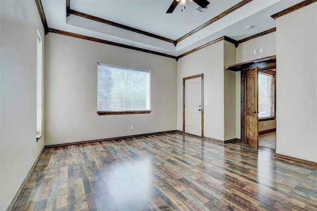 interior space with a raised ceiling, ceiling fan, crown molding, and hardwood / wood-style floors