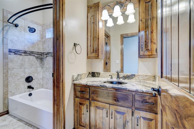 bathroom with tiled shower / bath and vanity