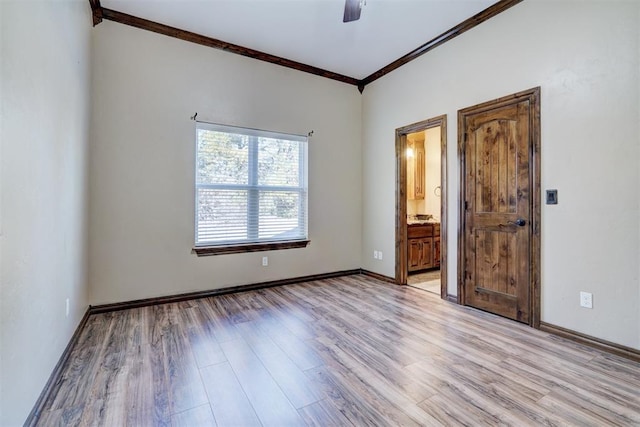 unfurnished room with crown molding, ceiling fan, and light hardwood / wood-style flooring