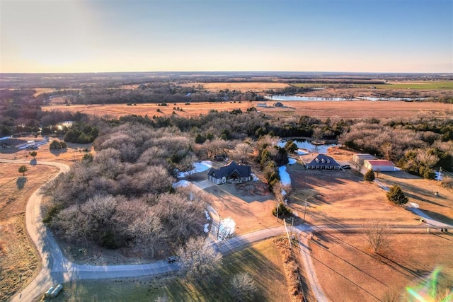 aerial view at dusk featuring a rural view