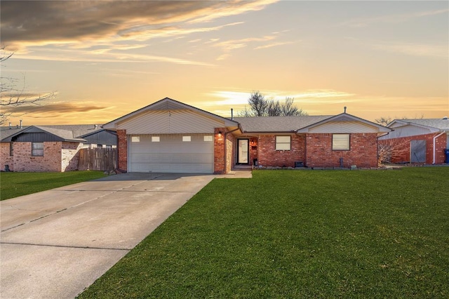 single story home with a garage and a yard