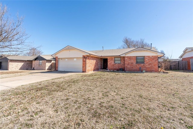 single story home with a front yard and a garage