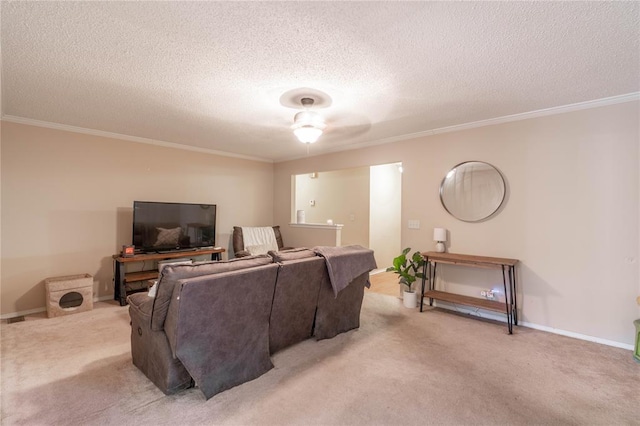 carpeted living room featuring a textured ceiling, ceiling fan, and crown molding