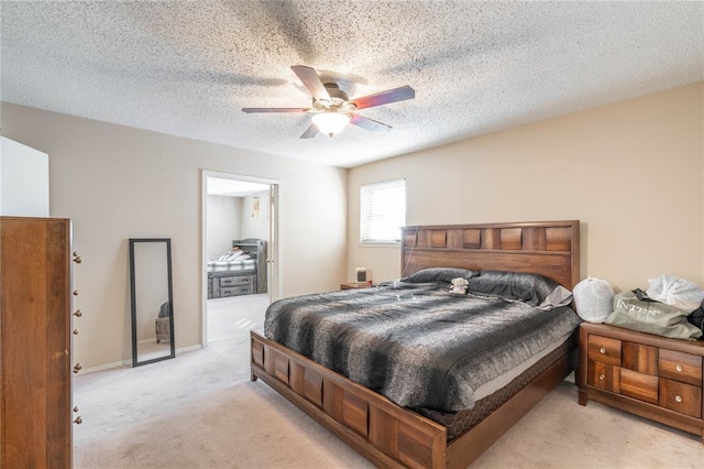 carpeted bedroom with a textured ceiling and ceiling fan