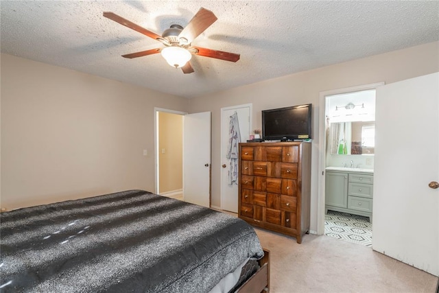 carpeted bedroom with sink, connected bathroom, a textured ceiling, and ceiling fan