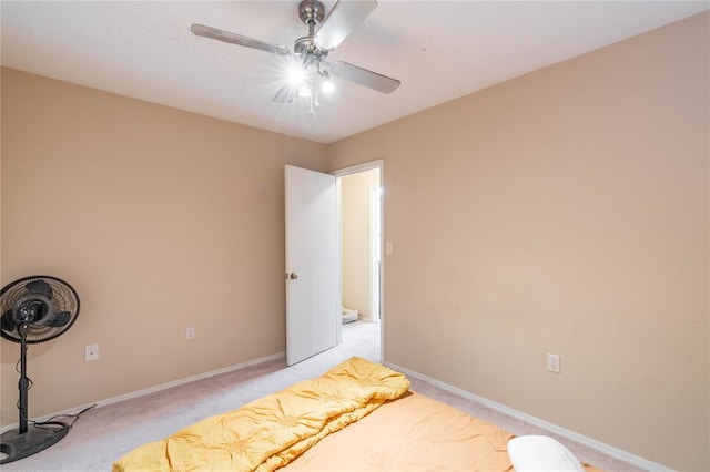 bedroom with ceiling fan and light colored carpet