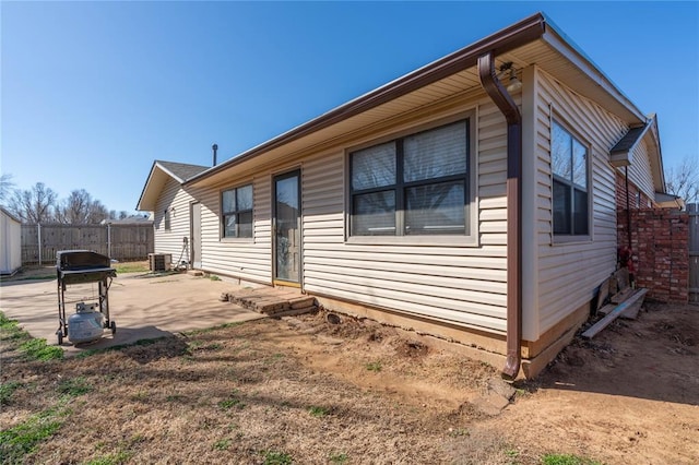 view of home's exterior with a patio and central AC unit