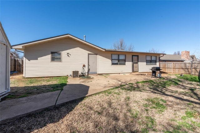 back of property with central air condition unit and a patio area