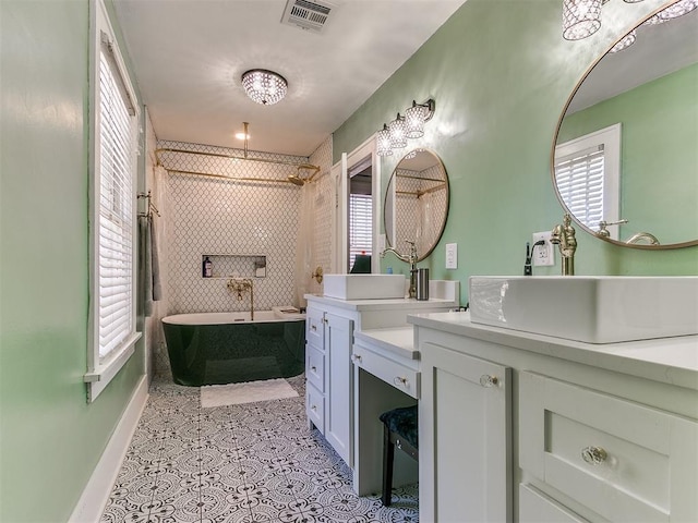 bathroom with vanity and separate shower and tub