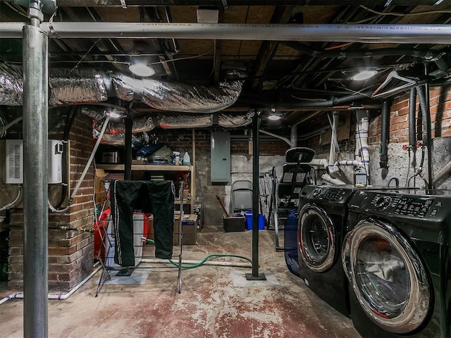 basement with washer and clothes dryer and electric panel