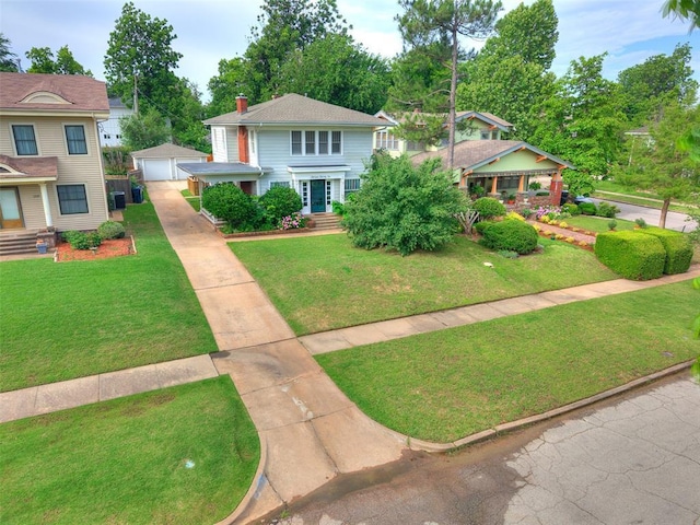 1322 NW 21st St, Oklahoma City, OK 73106 - view of front of home with driveway, an outbuilding, a garage, and a front lawn
