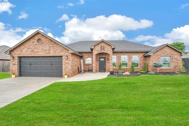 view of front of property with a front yard and a garage