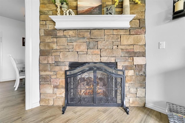 details featuring wood-type flooring and a stone fireplace