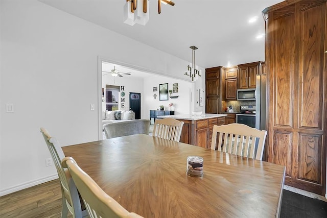 dining space with ceiling fan and dark hardwood / wood-style floors