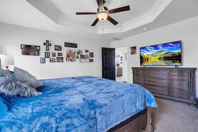 bedroom featuring ceiling fan, ornamental molding, carpet flooring, and a raised ceiling