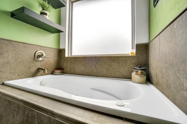 bathroom featuring tiled tub