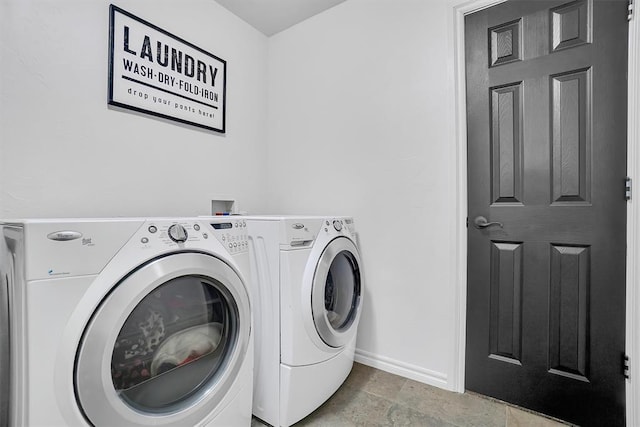 clothes washing area with separate washer and dryer