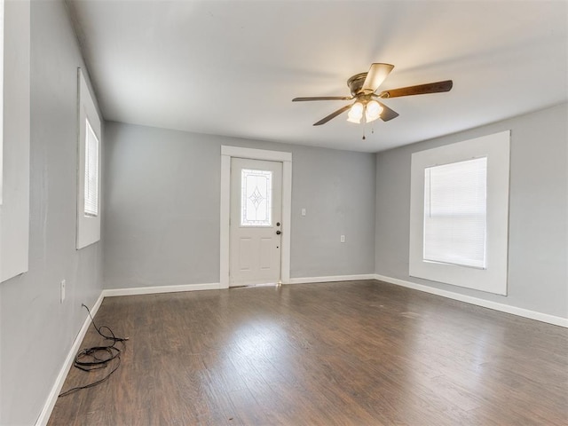 spare room featuring dark hardwood / wood-style flooring and ceiling fan