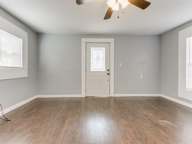 entryway featuring ceiling fan and dark wood-type flooring