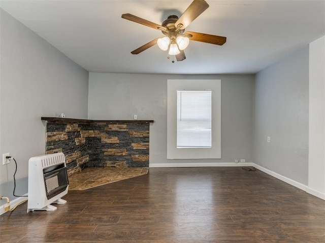 unfurnished living room with dark hardwood / wood-style flooring, ceiling fan, and heating unit