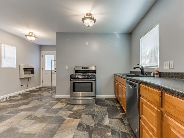 kitchen featuring sink, appliances with stainless steel finishes, and heating unit