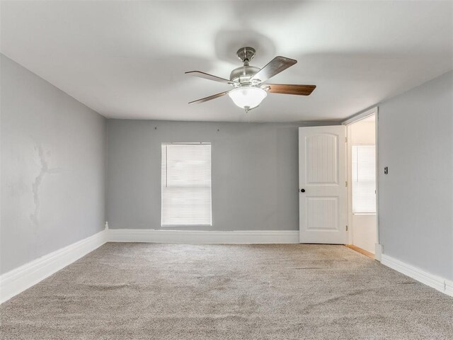 carpeted empty room featuring ceiling fan