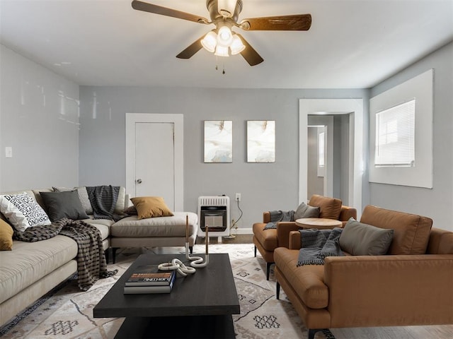 living room featuring ceiling fan and heating unit