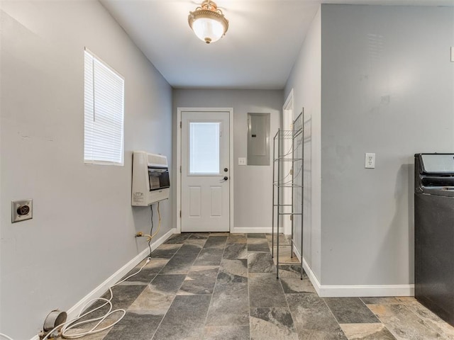 interior space featuring electric panel, a wealth of natural light, and heating unit