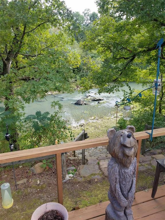 view of yard with a deck with water view