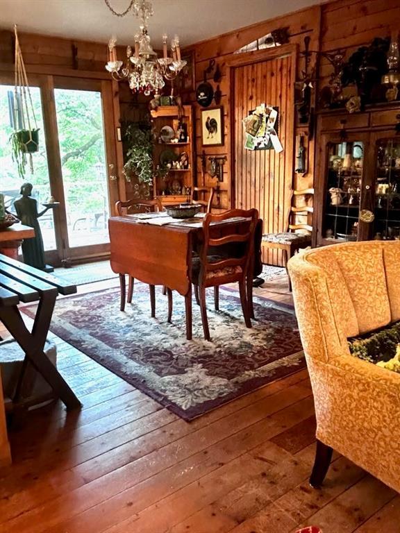 dining space with an inviting chandelier and hardwood / wood-style flooring