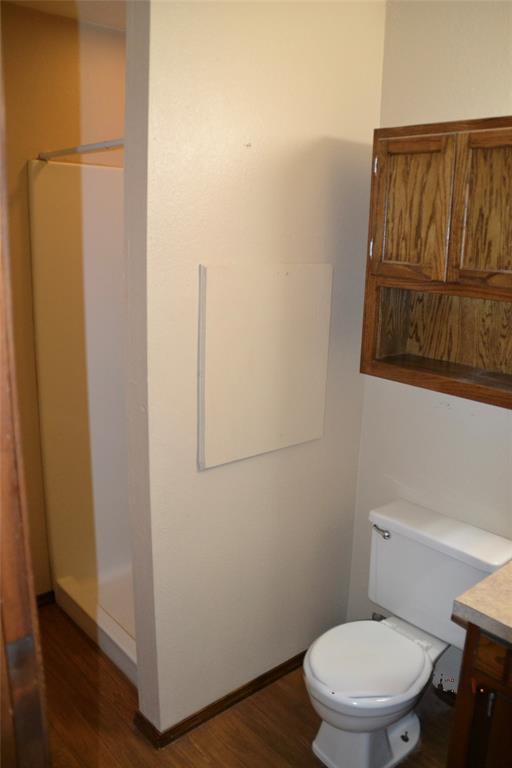 bathroom with vanity, hardwood / wood-style floors, and toilet