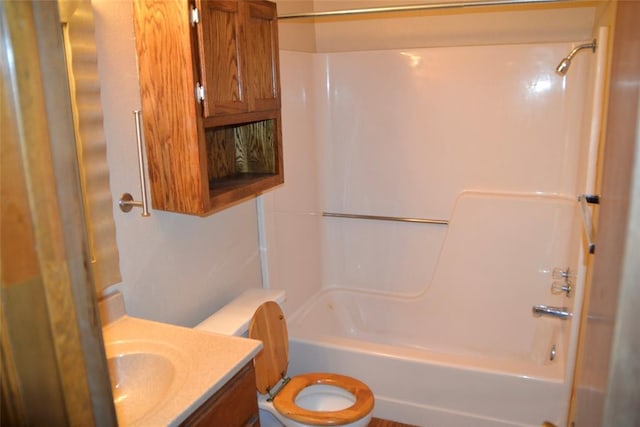 full bathroom featuring washtub / shower combination, vanity, and toilet