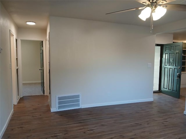 spare room featuring ceiling fan and dark hardwood / wood-style floors