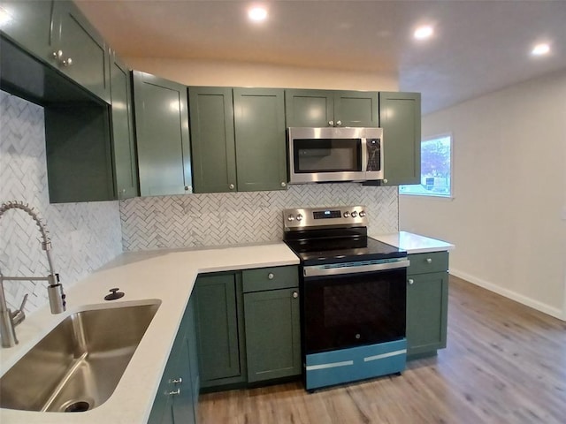 kitchen featuring stainless steel appliances and green cabinetry