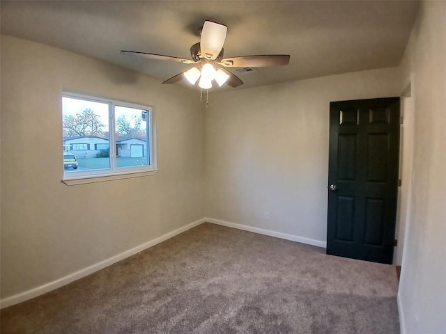 spare room with ceiling fan and carpet flooring