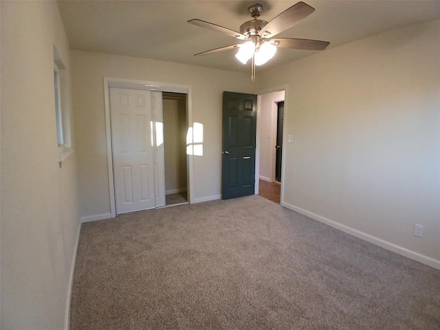 unfurnished bedroom featuring carpet flooring, ceiling fan, and a closet